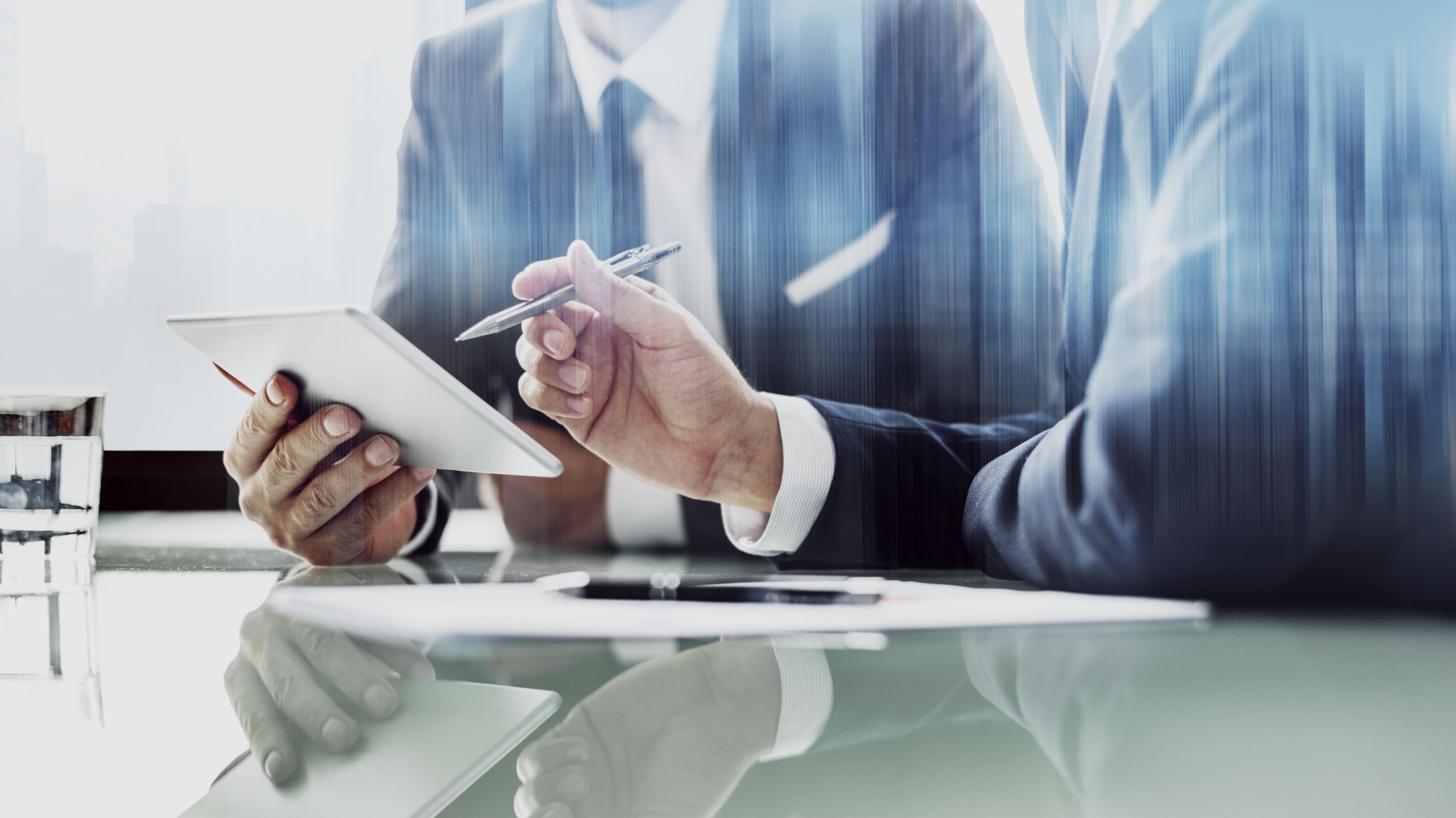 Two people in a meeting, their hands in the image