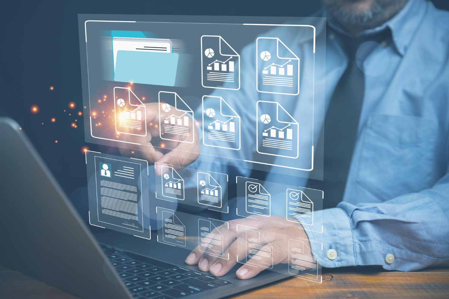 Image of a man working on a laptop with a screen displaying data