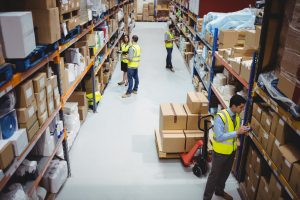 A warehouse worker using a hand scanner in a warehouse environment